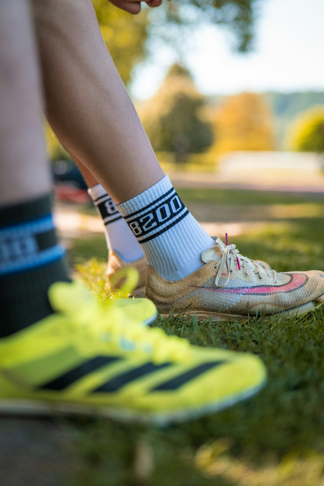 Close-up of running shoes and socks on grass