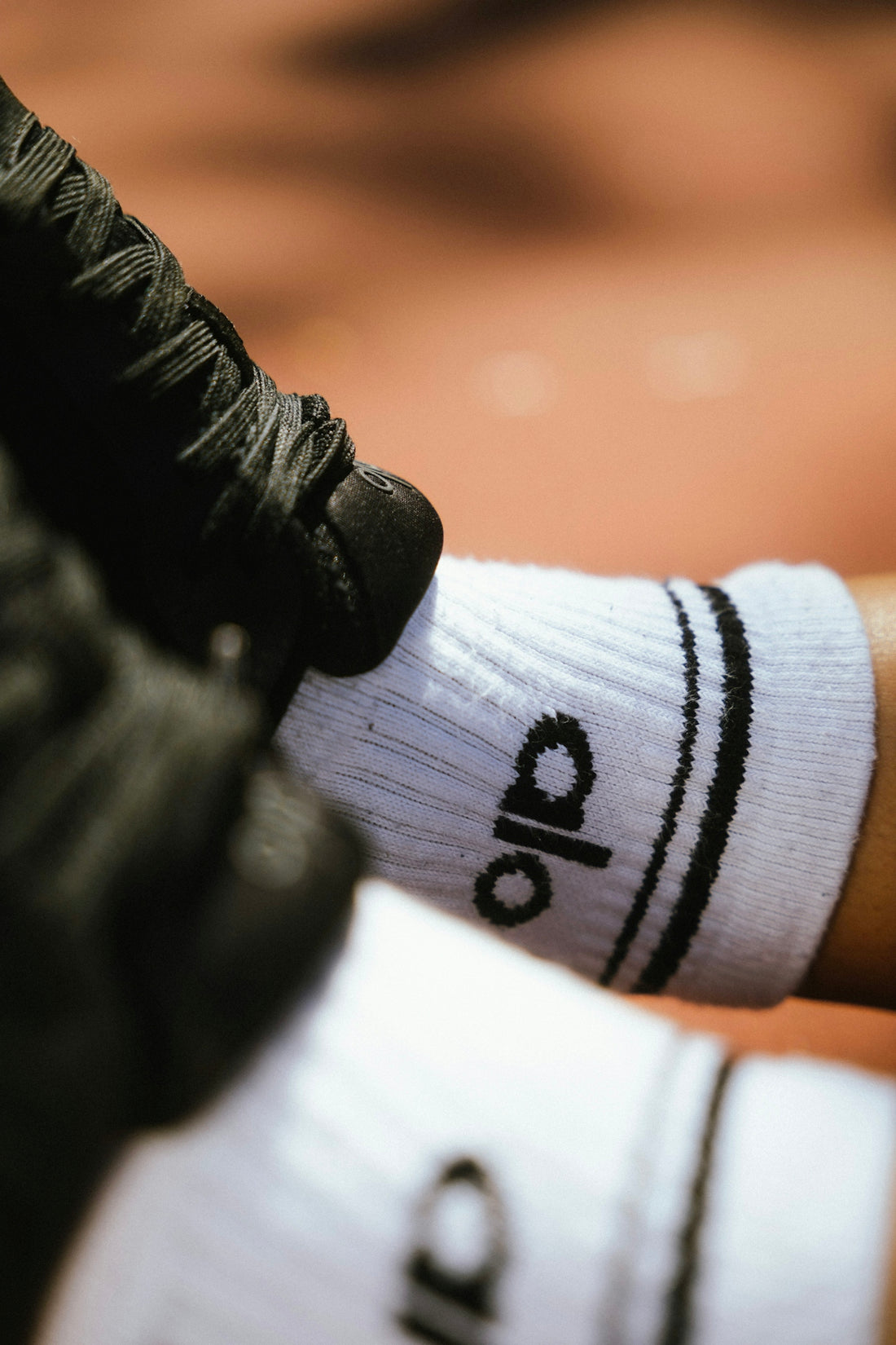 White socks with black stripes and logo.