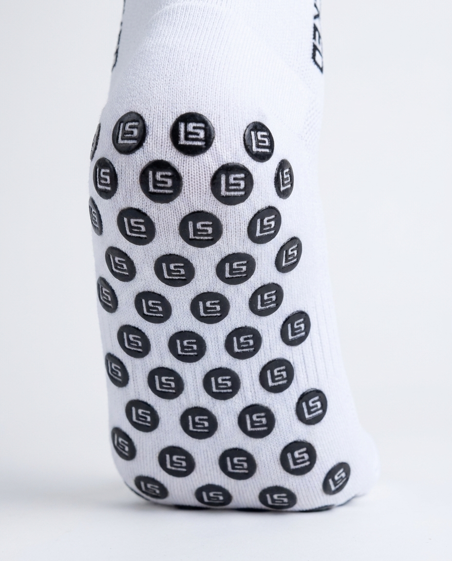 Close-up of StayLocked grip sock sole, showing the branded rubber grip pads that lock the foot in the boot